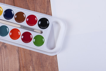 Watercolor paints with brush in box