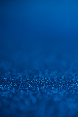Abstract dark blue glitter bokeh holiday background. Winter xmas holidays. Christmas.