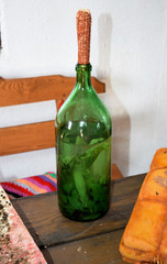 Tincture of horseradish and parsley on moonshine. A bottle of liqueur plugged corncobs