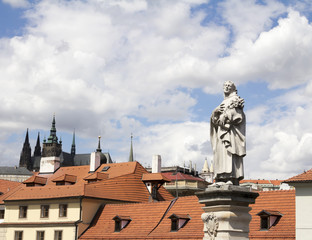 Fototapeta na wymiar Baroque Statues on the Prague Charles Bridge with beautiful Castle