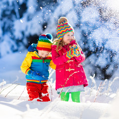 Children playing in snowy winter park