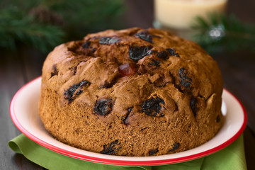 Fototapeta na wymiar Traditional Chilean Pan de Pascua Christmas Cake made with spices, dried fruits and raisins, photographed with natural light (Selective Focus, Focus on the front of the cake)