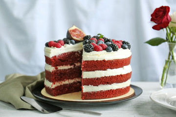 Tasty cake with berries on table