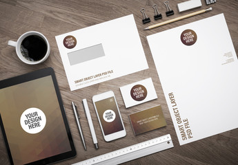 Smartphone and Stationery on Wooden Desk Mockup 1