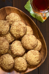 Homemade snickerdoodle cookies with cinnamon and sugar coating, photographed overhead on dark wood with natural light (Selective Focus, Focus on the cookies on the top)