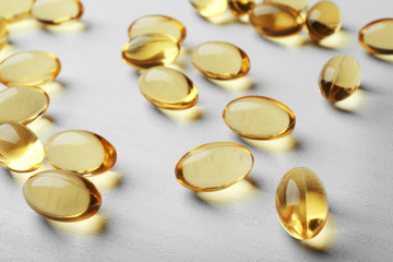 Cod liver oil capsules on light background