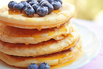 Stack of fresh pancakes with blueberry on plate closeup