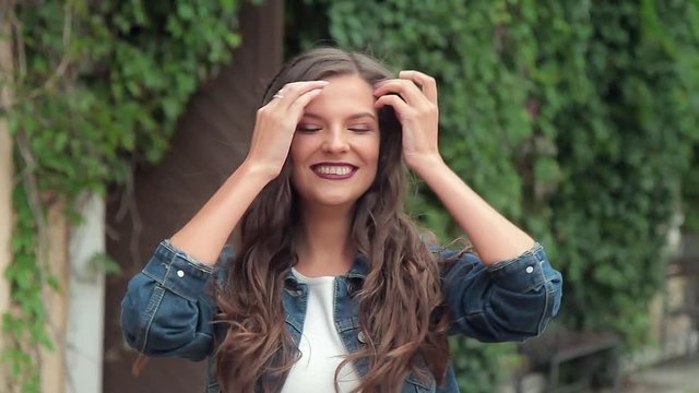 Happy young brunette girl smiling and laughing looking at camera
