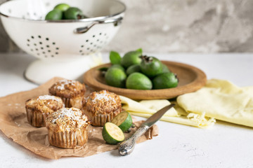 Feijoa muffins topped with shredded coconut in light composition