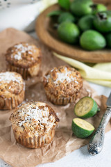 Feijoa muffins topped with shredded coconut in light composition