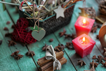 Composition of candles and natural decor on wooden background, close up view