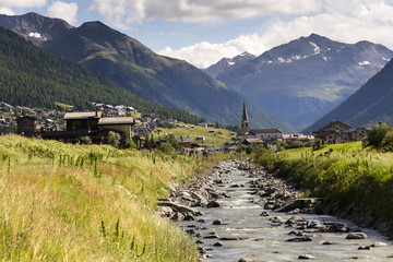 Spol river with church of Santa Maria in Livigno, Italy