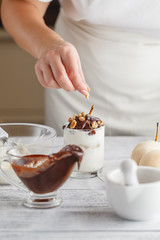Close up on delicious peeled pear with melted chocolate on top f