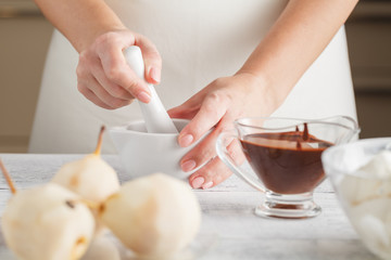 Woman cooking with mortar on white background