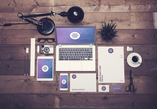 Laptop, Tablet, Smartphone, and Stationery on Dark Wooden Desk