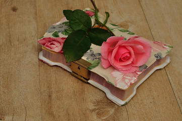 A closed notebook with a pink flower