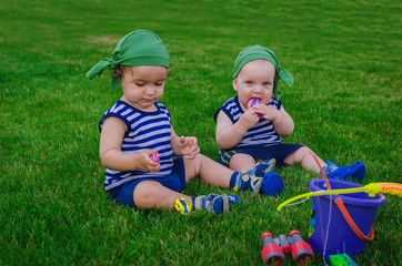 Two little boys playing in the toddlers fishermen sitting on fre