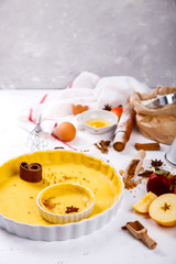 Baking Background. Ingredients  for baking Apple Pie  - apples,spices ,flour,  rolling pin, eggs, egg yolks, butter served, milk on white background.selective focus.