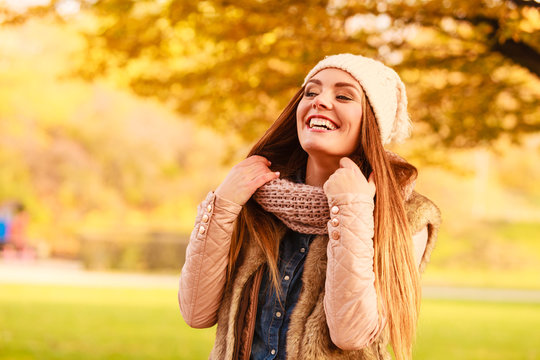 Smiling woman relaxing outdoor in autumnal park