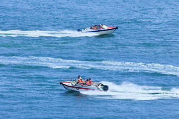 Speed boats passing each other in a blue sea