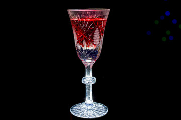 glass with red wine and candles