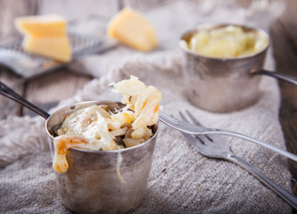 Hot appetizer with cheese,chicken meat,mushrooms.Baked Cheese.selective focus.