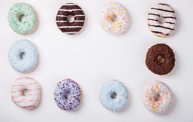 Donuts in colored glazes on a white background.Pastries,dessert.Copy space.selective focus.