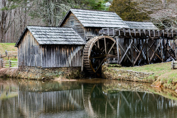 Historic mill house with water wheel and pond.  