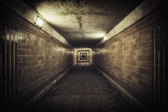 Empty underpass tunnel at night, desaturated colors