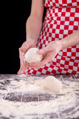 Cook preparing dough for baking in the kitchen