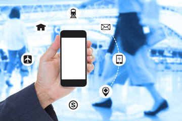 Businessman Hand holding blank screen mobile phone with blurred image of crowd