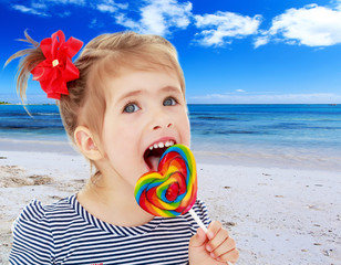 Girl licks candy on a stick