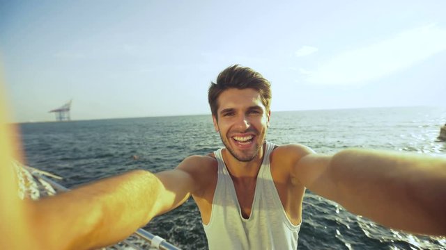 Funny young man taking selfies and resting after morning jogging.