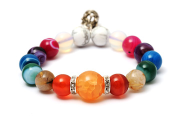 Colorful of agate,jasper bracelet decorate with silver crown pendant with white isolated background