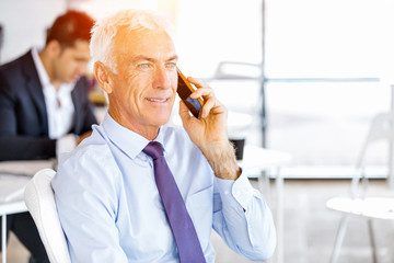 Businessman at the office with mobile phone