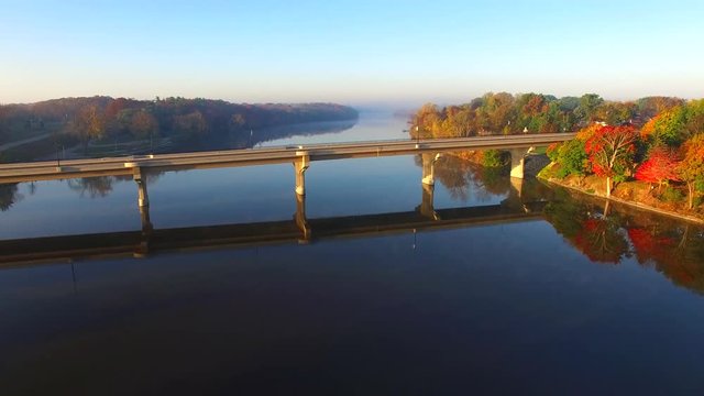 Scenic flight over bridge with Autumn colors.
