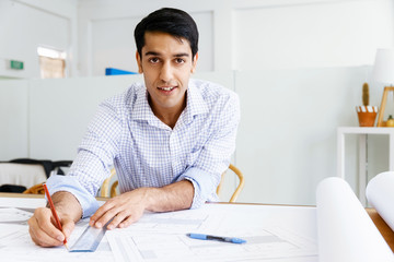 Young man architect in office