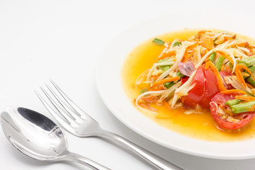 Spicy green papaya salad or somtum isolated on white background with copy space for text, Thai cuisine