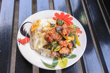 Rice and stir-fried crispy pork and basil topped with Fried egg