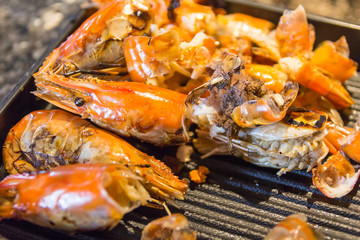 Scrap tires shrimp dish on black plate