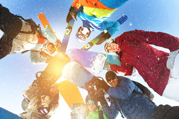 Group happy snowboarders skiers circle