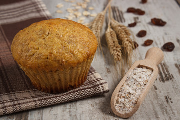 Fresh muffin with oatmeal, rye flour and ears of rye grain, delicious healthy dessert
