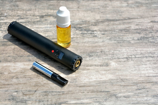 Electronic cigarettes and bottles of liquid. 