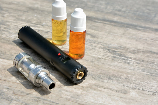 Electronic cigarettes and bottles of liquid. 