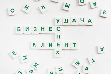 Scrabble words in russian, business concept. Featured words are: Customer, Business, Success, Luck. White background, lot of single letters, white background