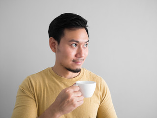 Asian man drinks coffee.