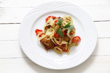 Asian cuisine fried chicken with turmeric, onion and chili