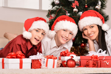 Fototapeta na wymiar Mom and children in santa hats