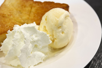 honey toast is ice cream with whipped cream and bread topped wit