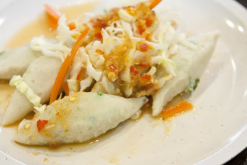 Spicy fish ball or meat ball with vegetable on white dish